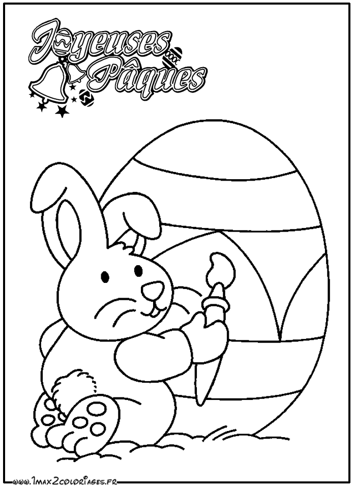 Coloriage Un lapin de pâques peint un oeuf